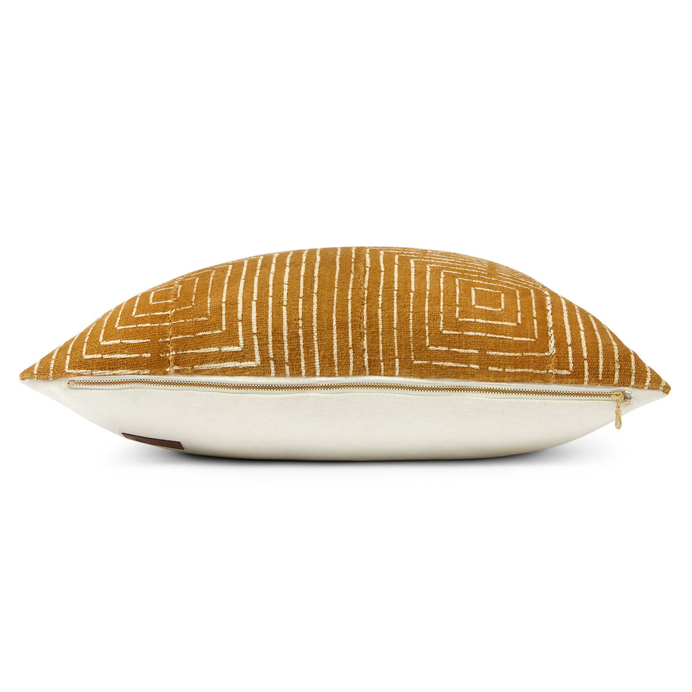 This is a full side view of our mudcloth pillow in mustard with geometric white squares and exposed YKK brass zipper.